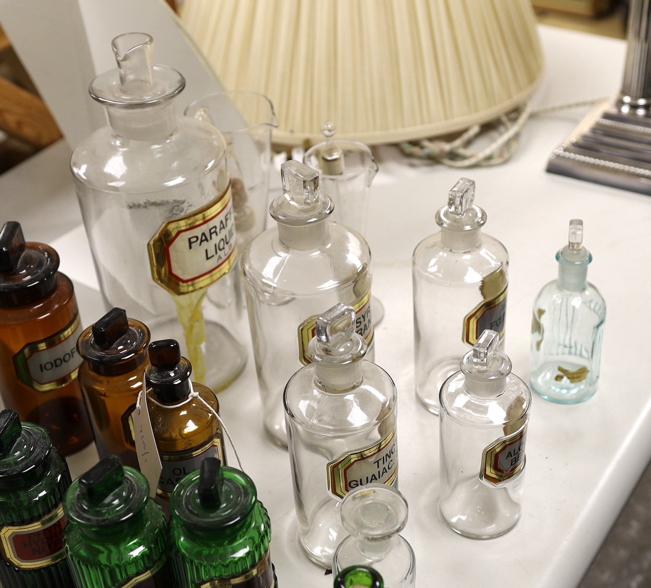 A collection of apothecary bottles, two measures and files, tallest bottle 27cms high